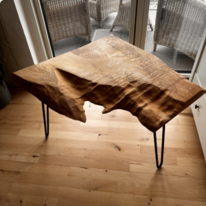 Live-edge walnut charcuterie board in black walnut with hairpin legs